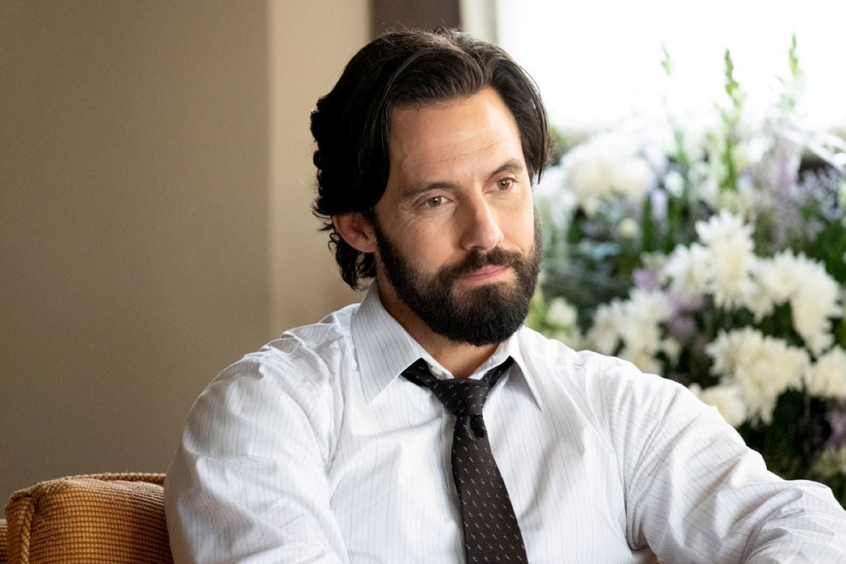 'This Is Us' Season 6 Episode 4 actor Milo Ventimiglia, in character as Jack Pearson, wears a white long-sleeved button-up shirt and black tie.