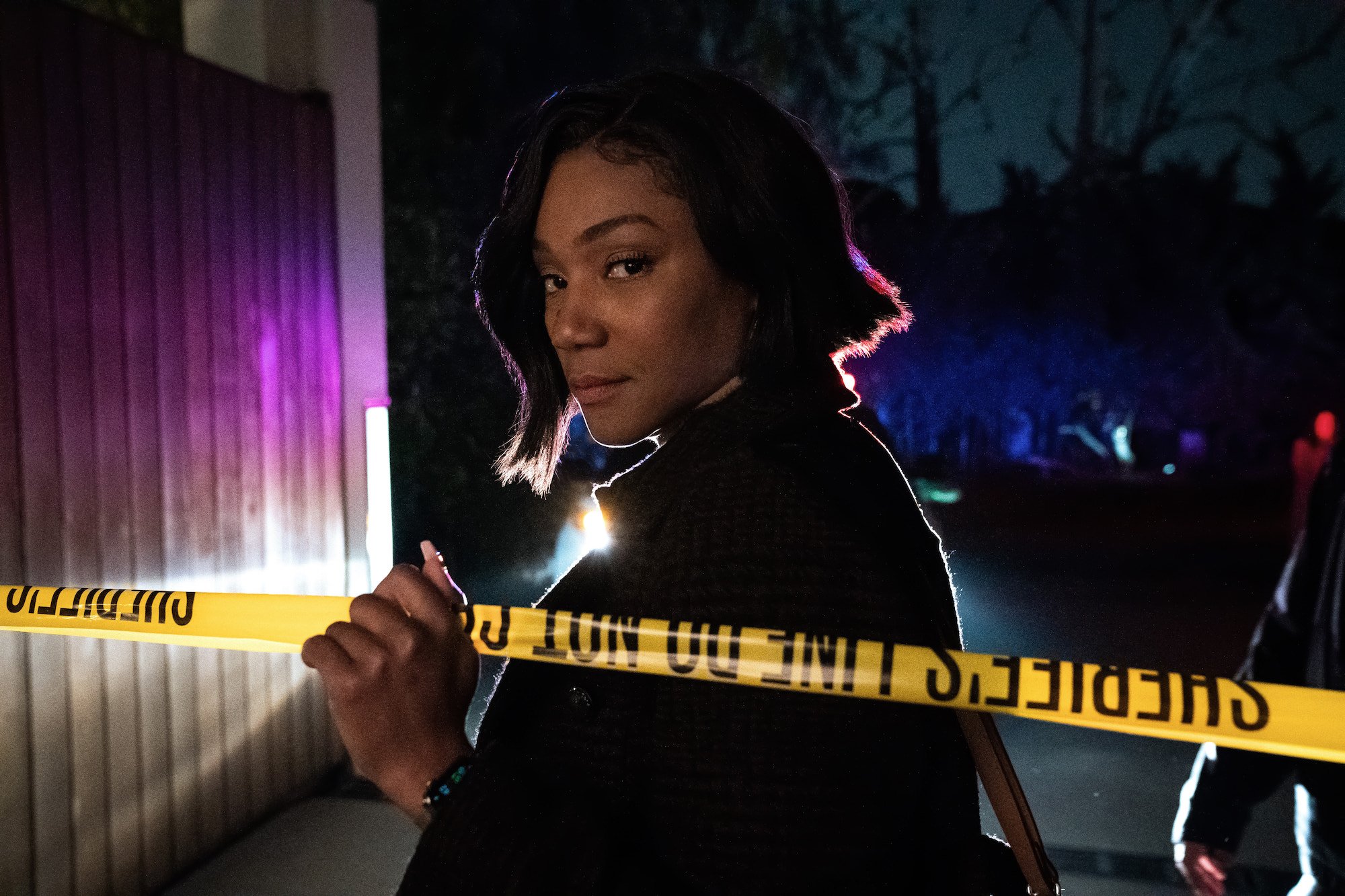 Tiffany Haddish holds up police tape in 'The Afterparty'
