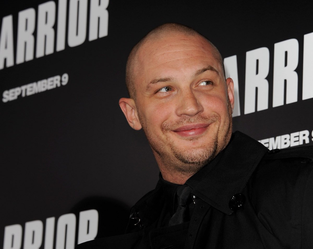 Actor Tom Hardy smiles at cameras during the red carpet premiere of 'Warrior'