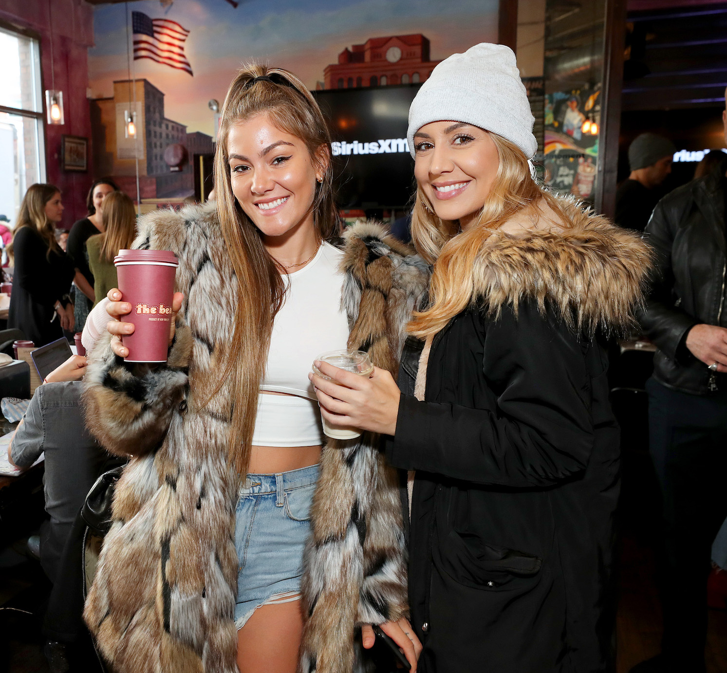 Tori Deal from MTV's 'The Challenge' Season 37 smiling with Ashley Kelsey as they attend SiriusXM's 'Dial Up The Moment' Pop-Up Performance