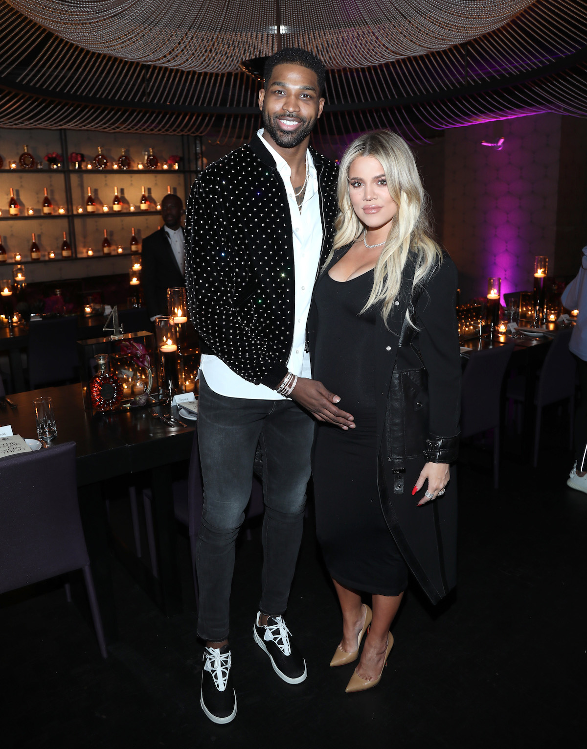 Tristan Thompson and Khloe Kardashian pose together at an event.