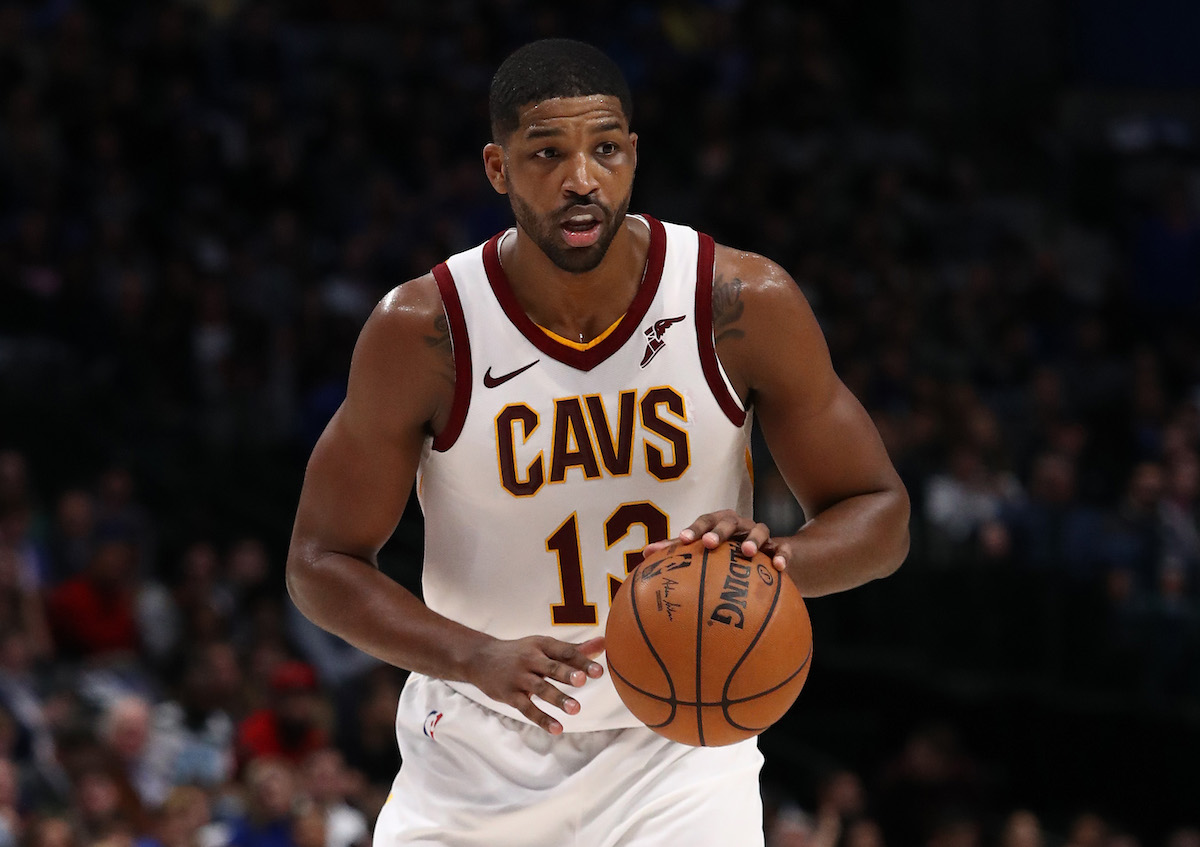 Tristan Thompson holds a basketball.