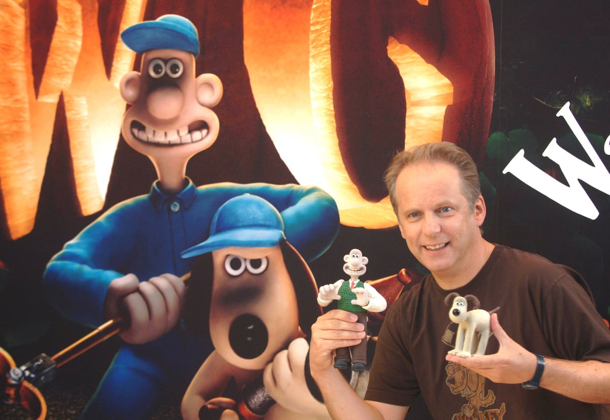 Nick Park, creator of Wallace & Gromit, poses with figurines of the characters in front of a poster for ‘Wallace & Gromit: The Curse of the Were-Rabbit’