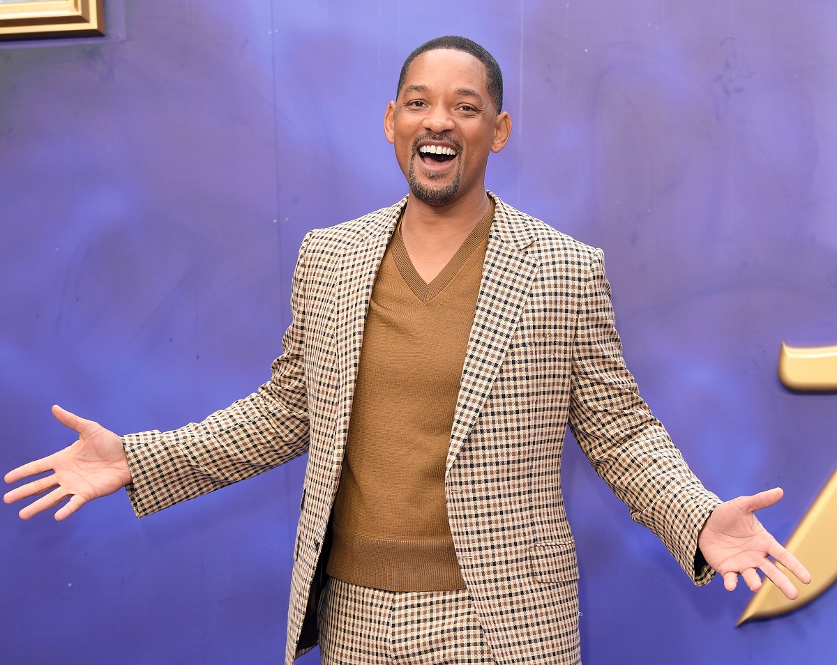 Will Smith smiling in a brown suit.