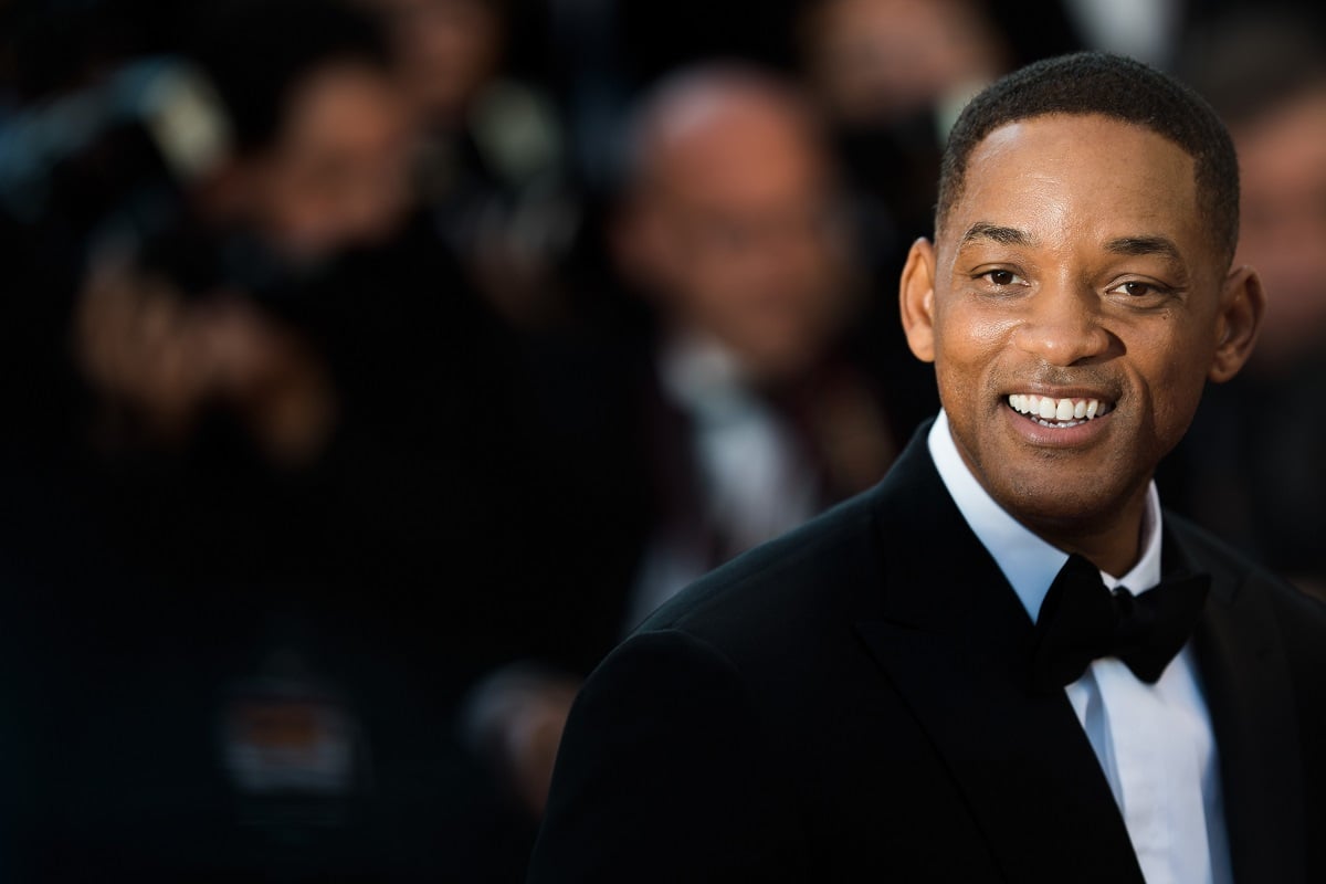 Will Smith smiling in a suit.