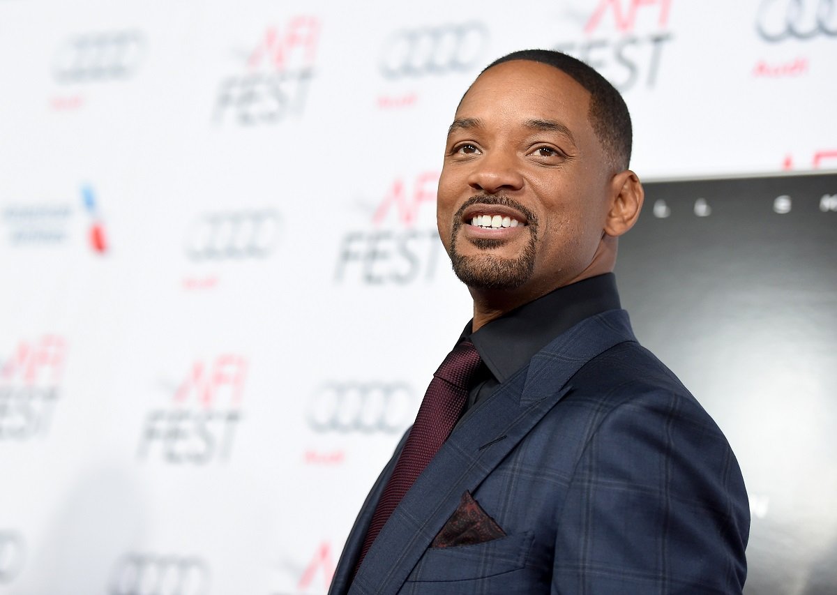 Will Smith smiling while wearing a suit.