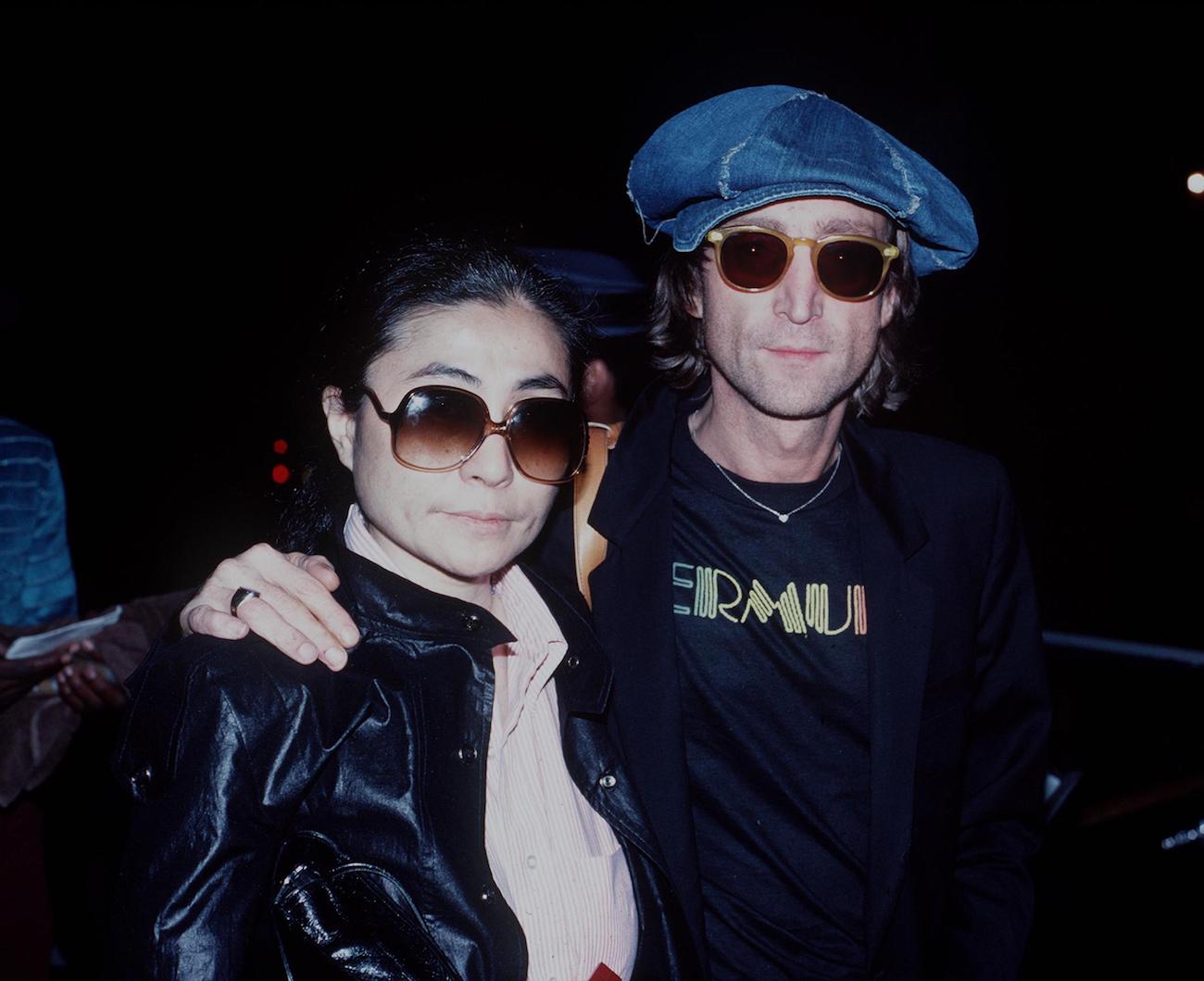 Yoko Ono and ex-Beatle John Lennon wearing sunglasses in New York City in 1980.