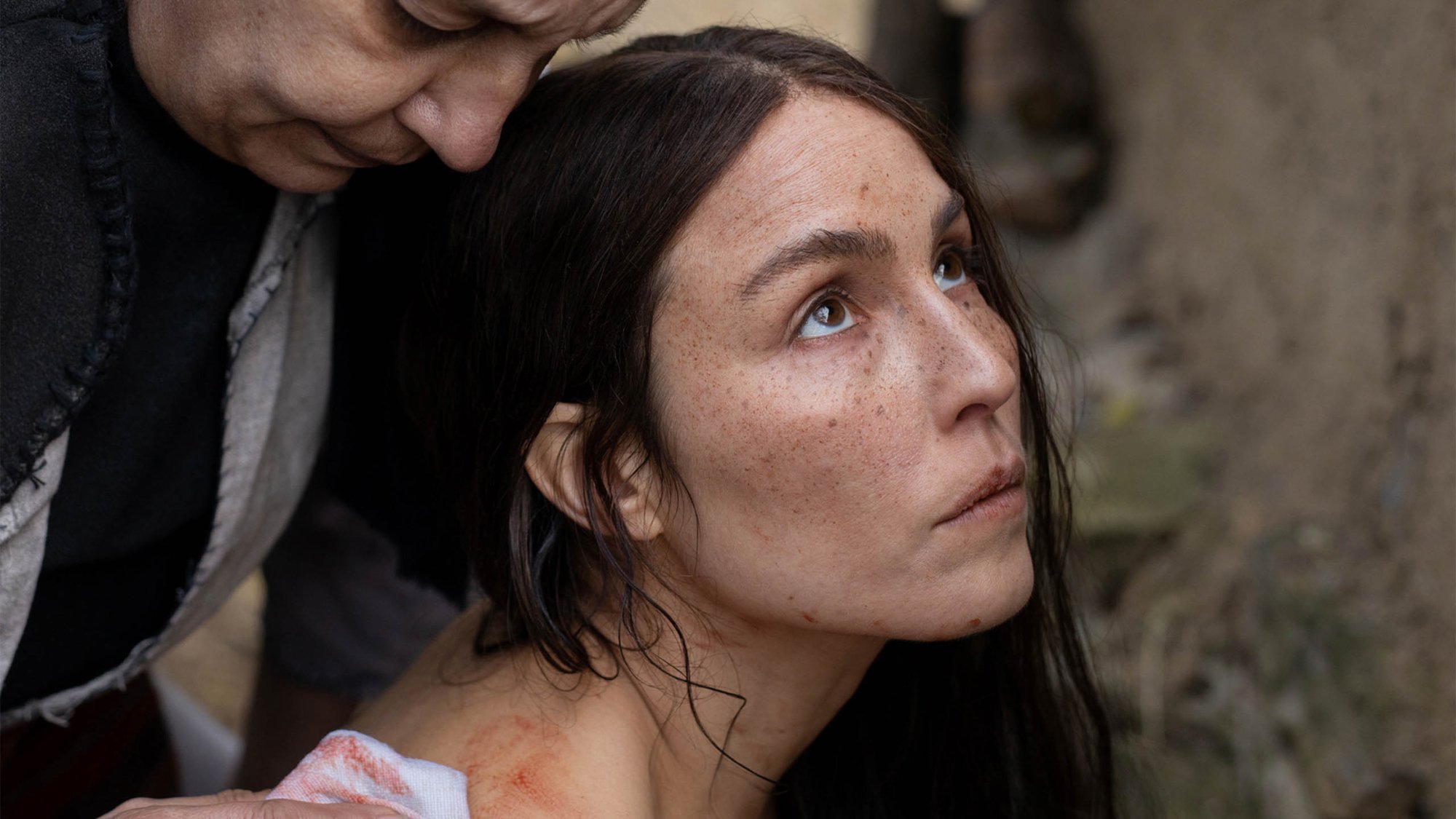 'You Won't Be Alone' Noomi Rapace as Bosilka looking up while she's being washed