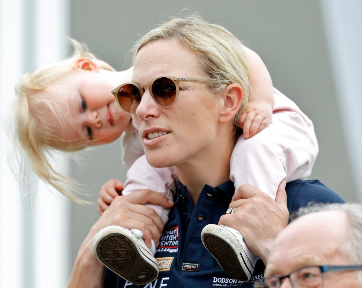 Zara Tindall carries daughter Lena Tindall on her shoulders as they attend day 2 of the 2019 Festival of British Eventing at Gatcombe Park on August 3, 2019 in Stroud, England