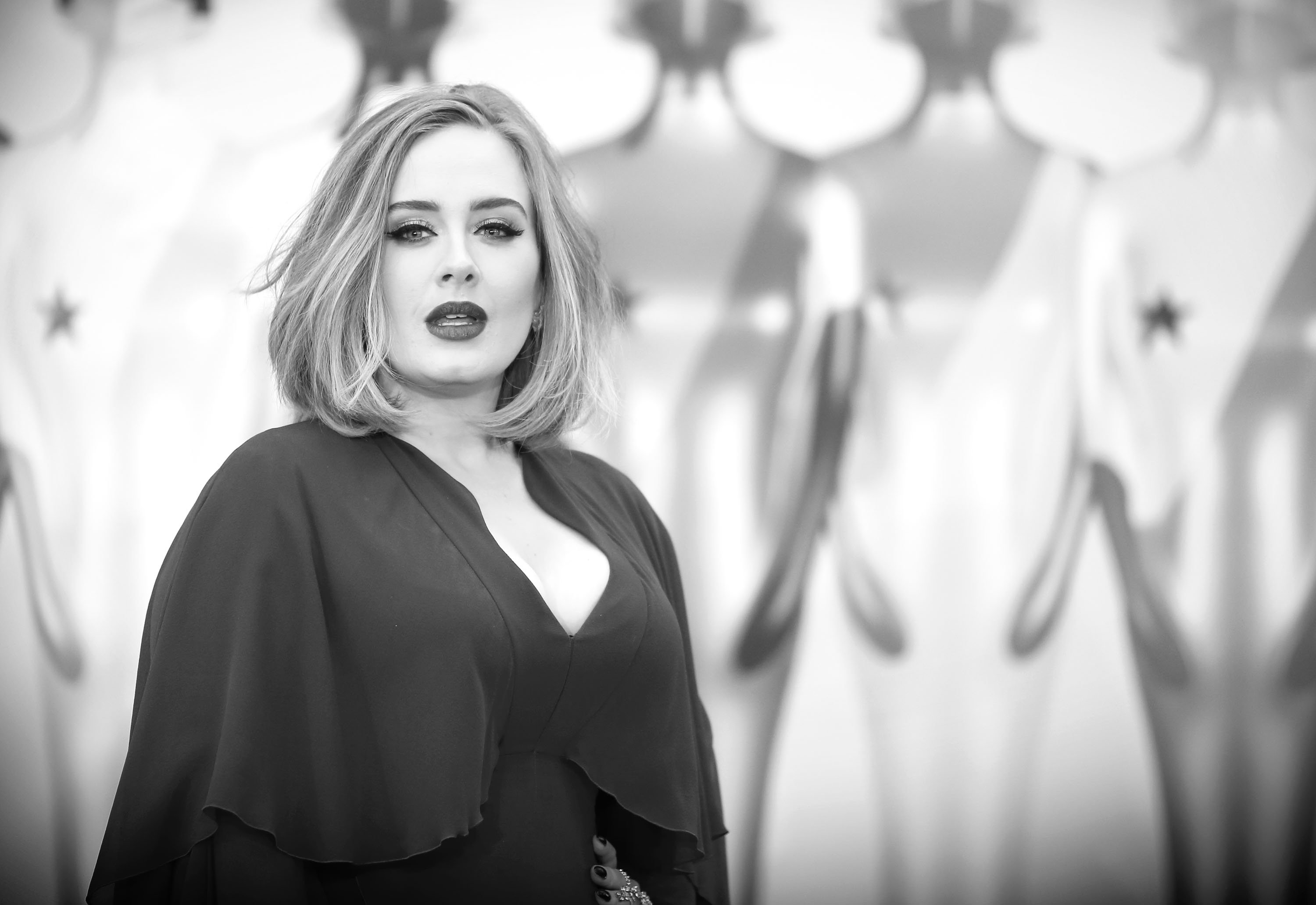 Adele in front of mannequins