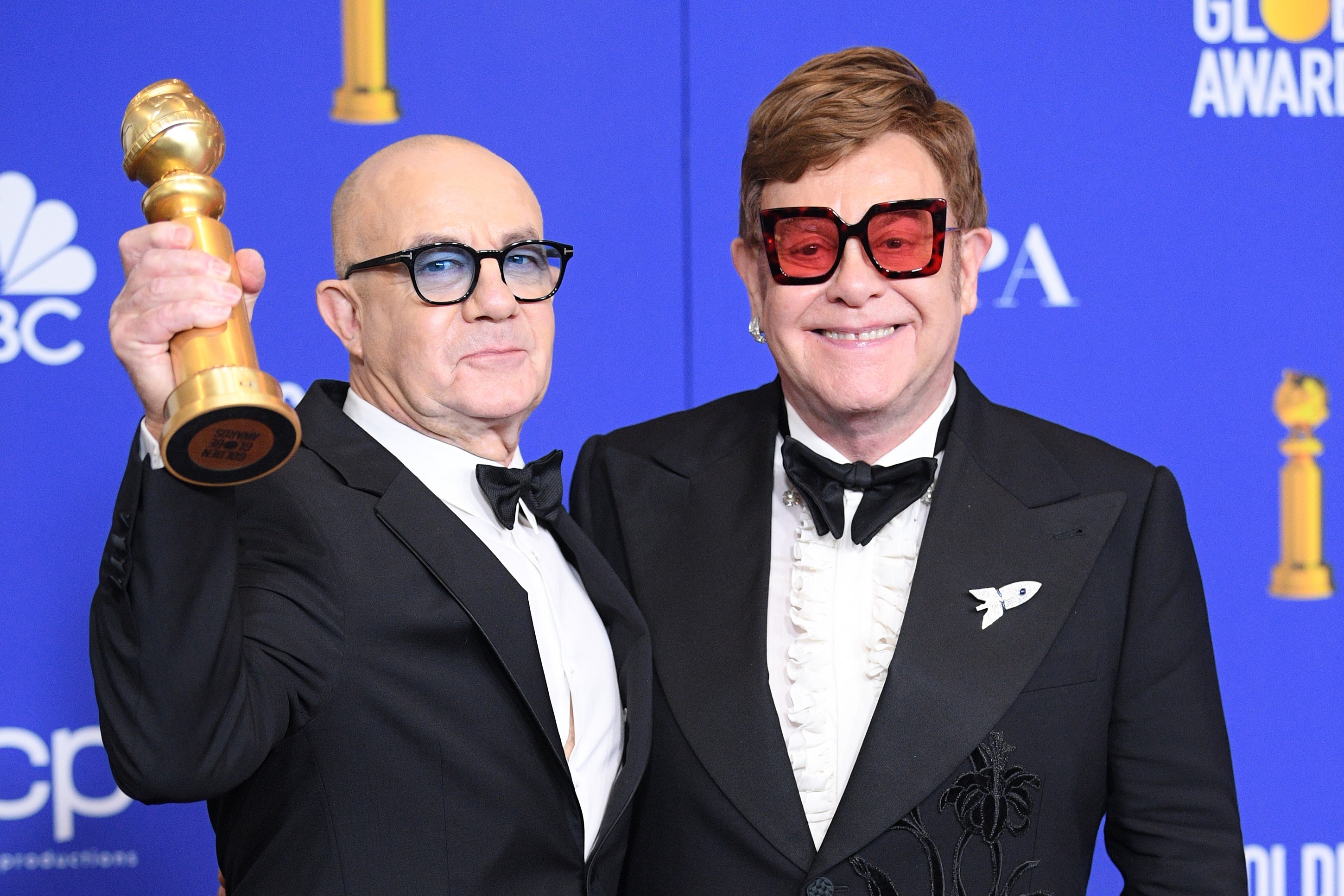 Bernie Taupin and Elton John wearing suits