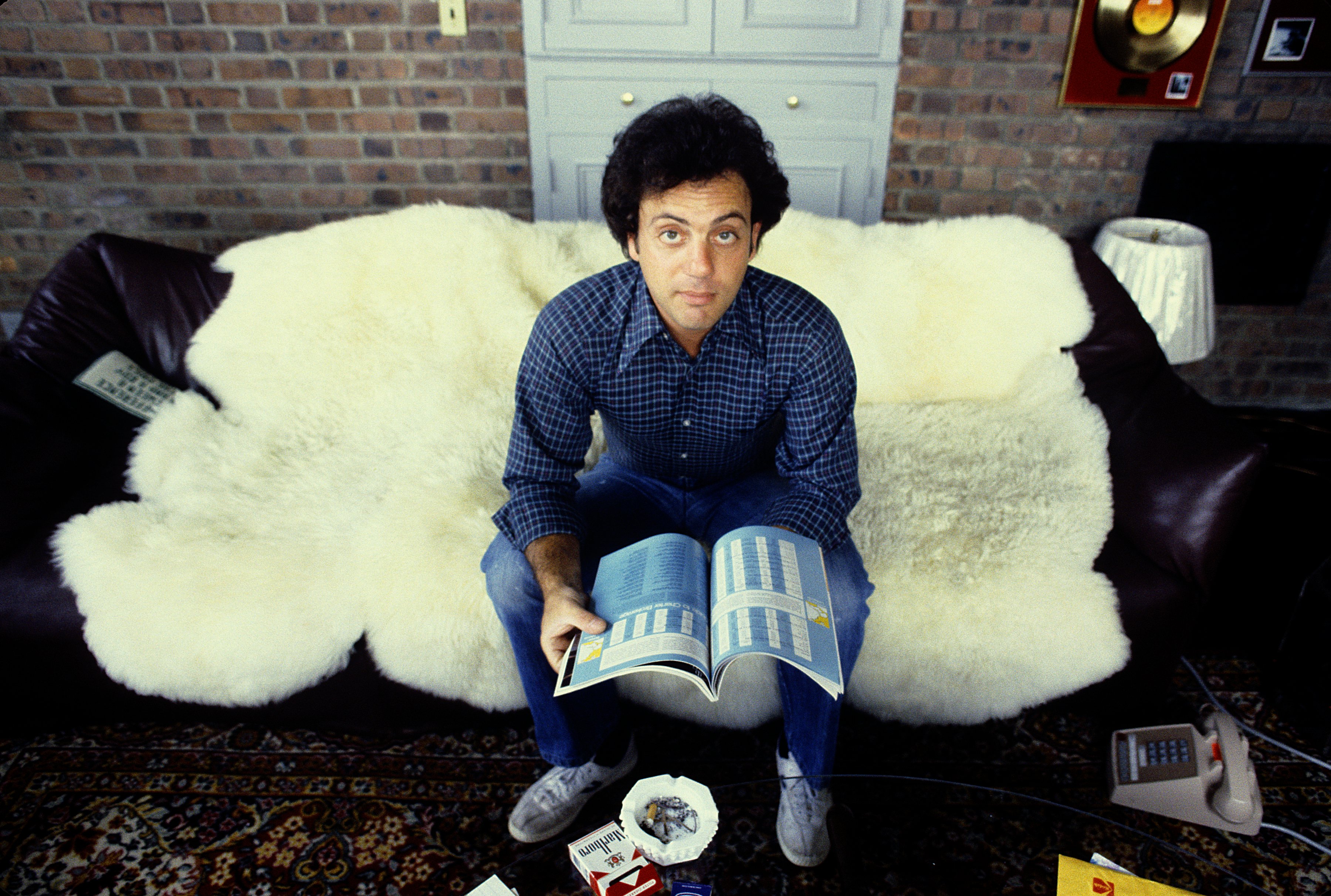 Billy Joel sitting on a couch