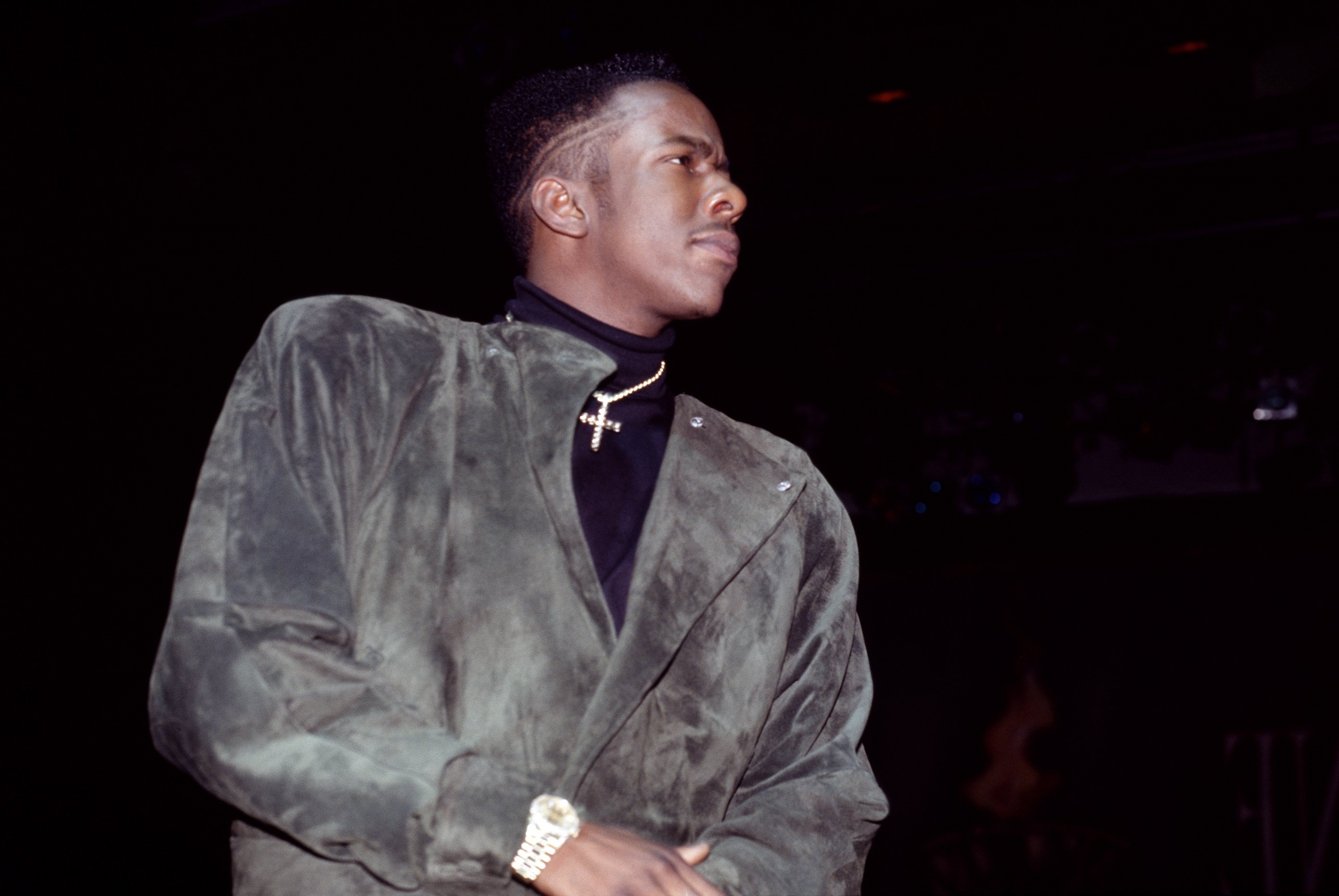 Bobby Brown wearing a cross necklace