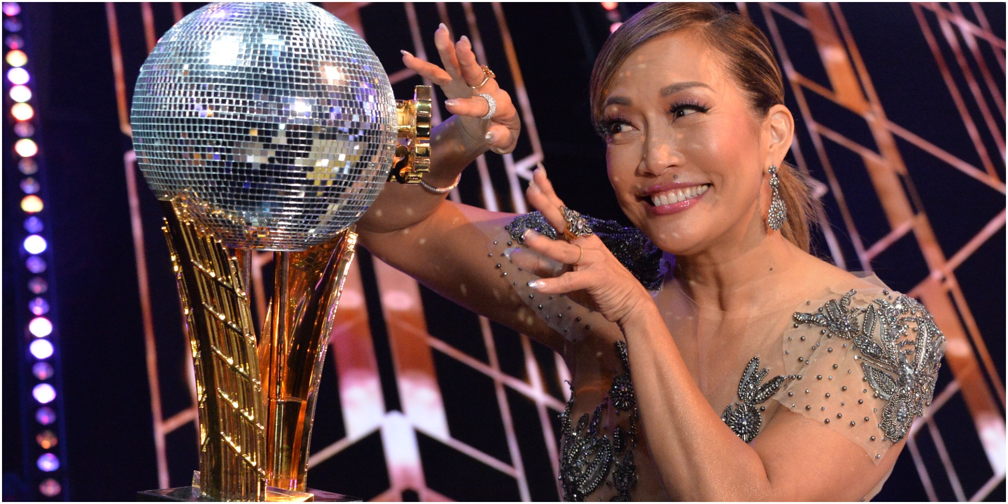 Carrie Ann Inaba looking at a mirrorball on the set of Dancing with the Stars season 30.