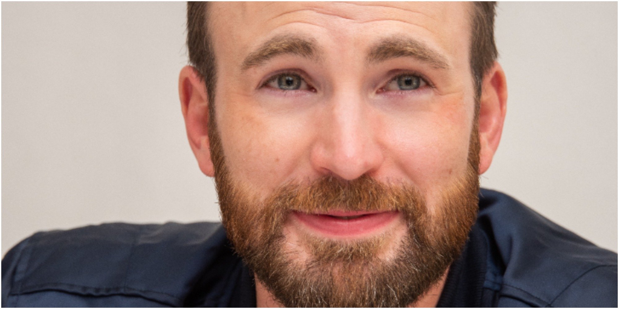 Actor Chris Evans poses for a 2019 photograph wearing a blue shirt.