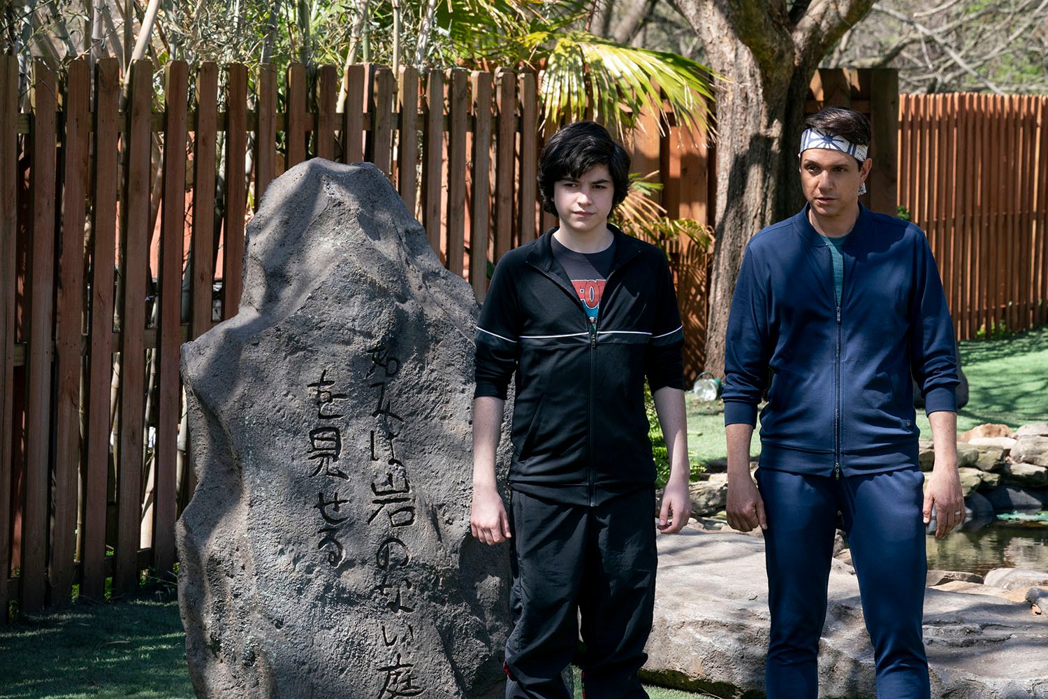 Griffin Santopietro as Anthony LaRusso and Ralph Macchio as Daniel LaRusso in Cobra Kai Season 4.