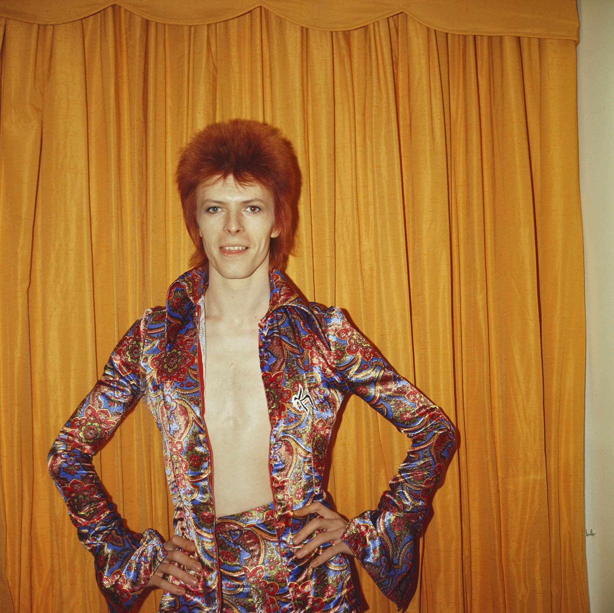 David Bowie in front of a curtain