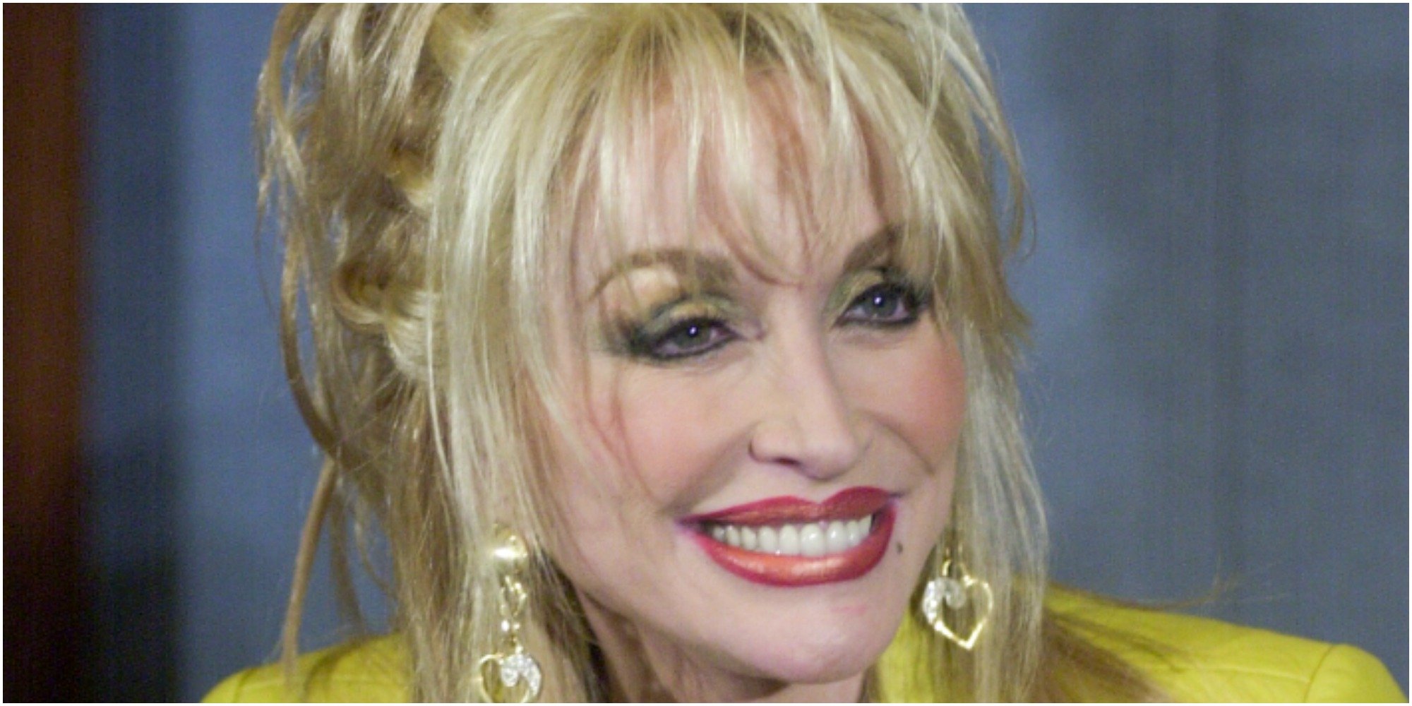 Dolly Parton smiles for a paparazzi photograph.