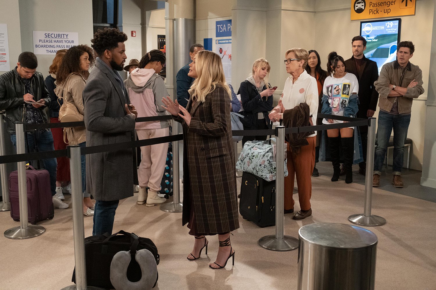 Daniel Augustin as Ian and Hilary Duff as Sophie have a discussion in a crowded airport in How I Met Your Father