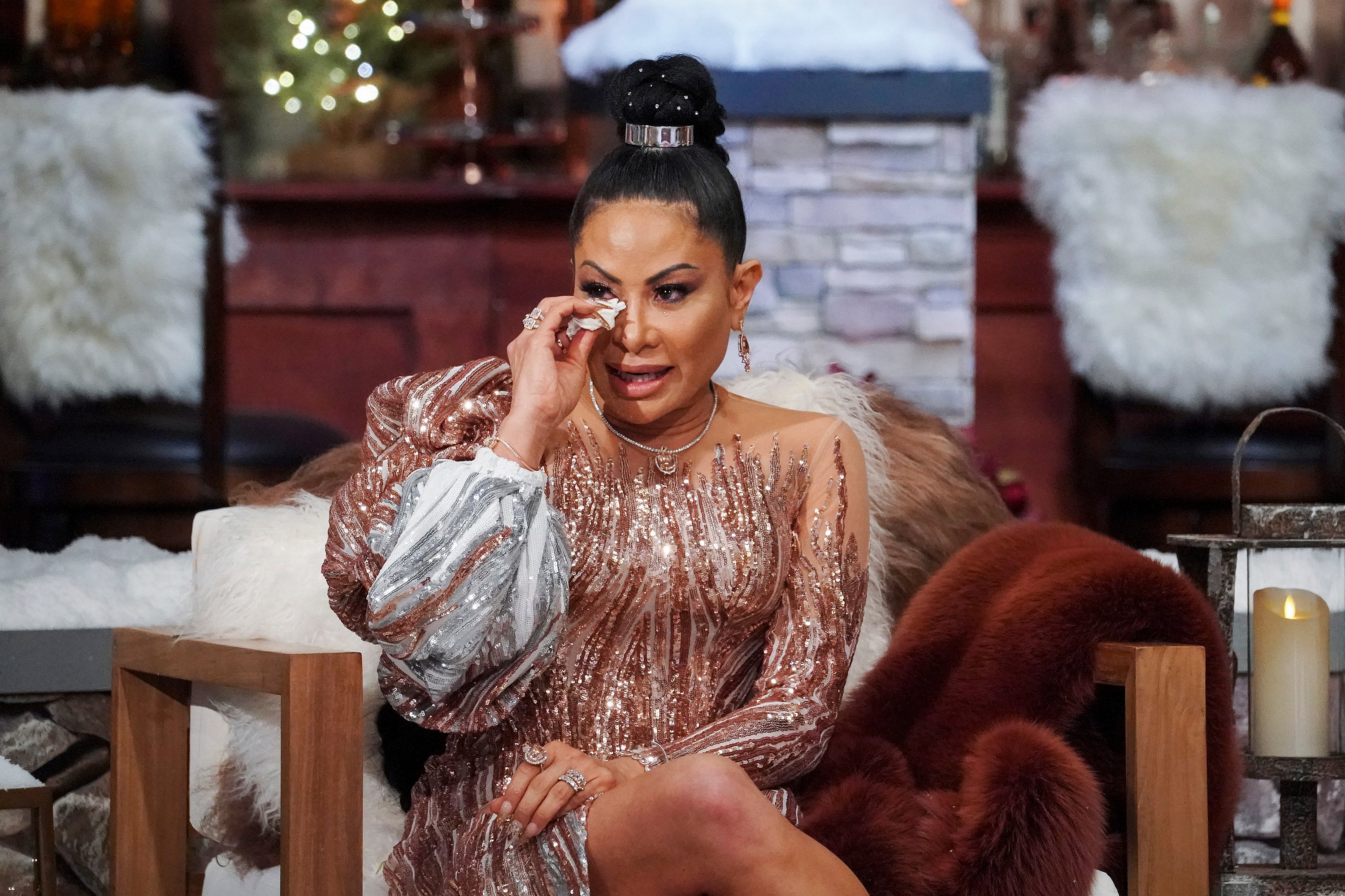 Jen Shah sitting in a chair and wiping off tears during the 'RHOSLC' Season 1 reunion