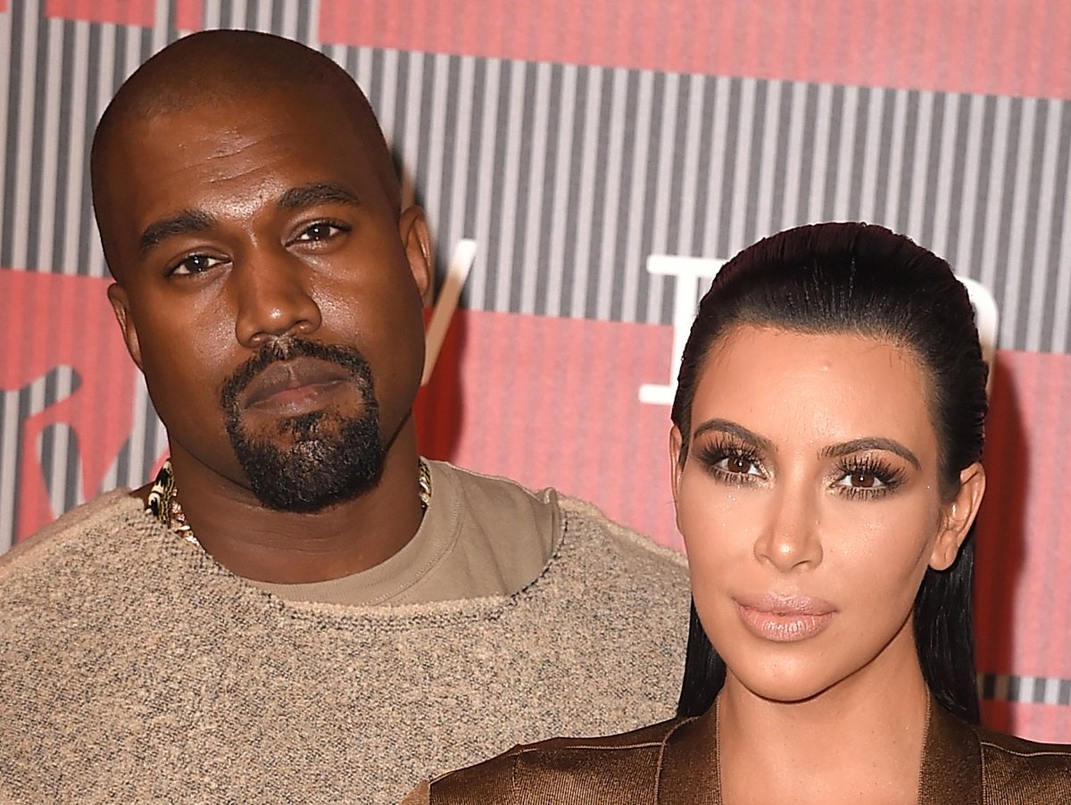 Kanye West and Kim Kardashian pose together at an award show.