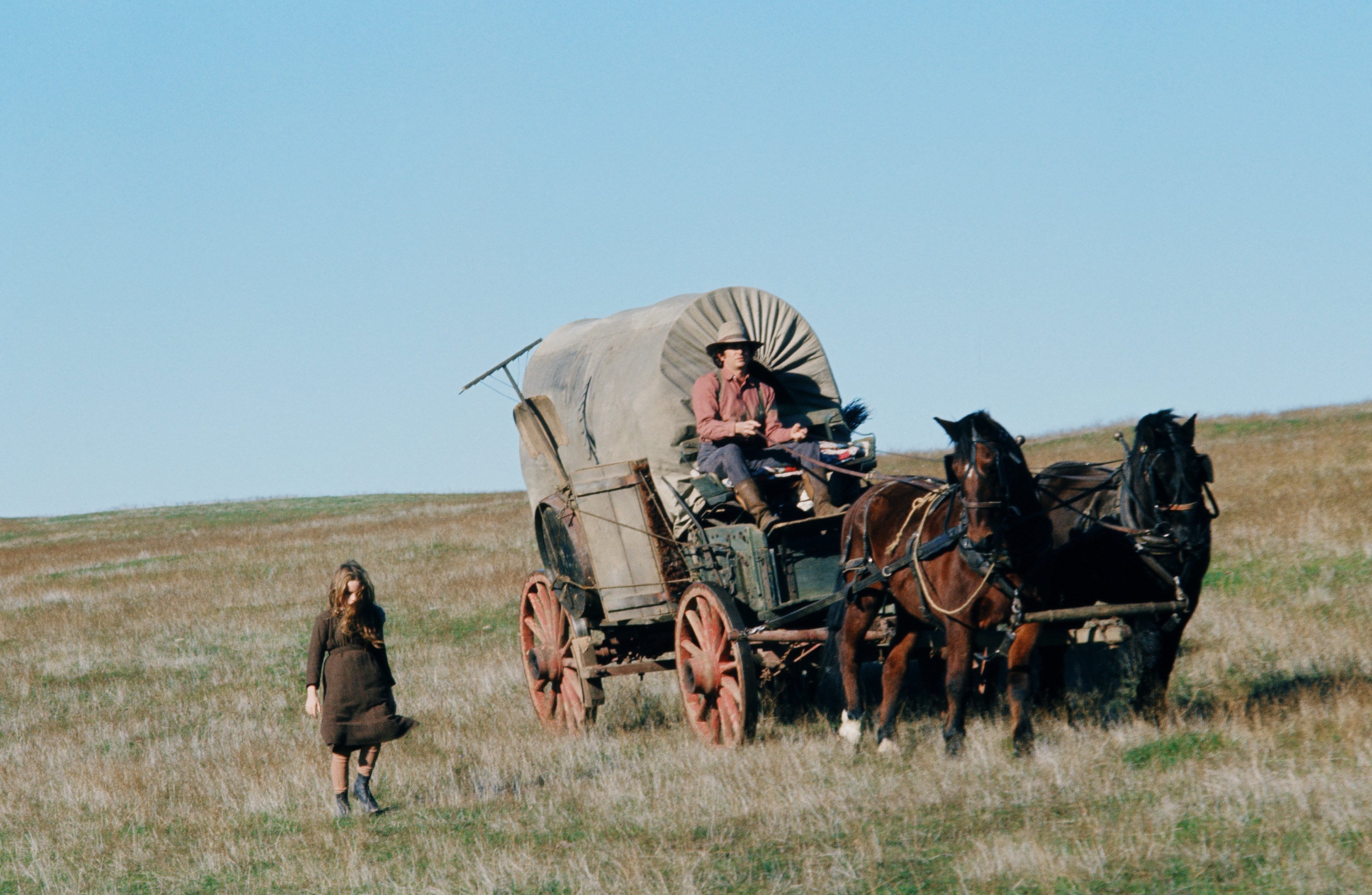 Michael Landon as Charles 'Pa' Ingalls in the wagon on the set of 'Little House on the Prairie.'