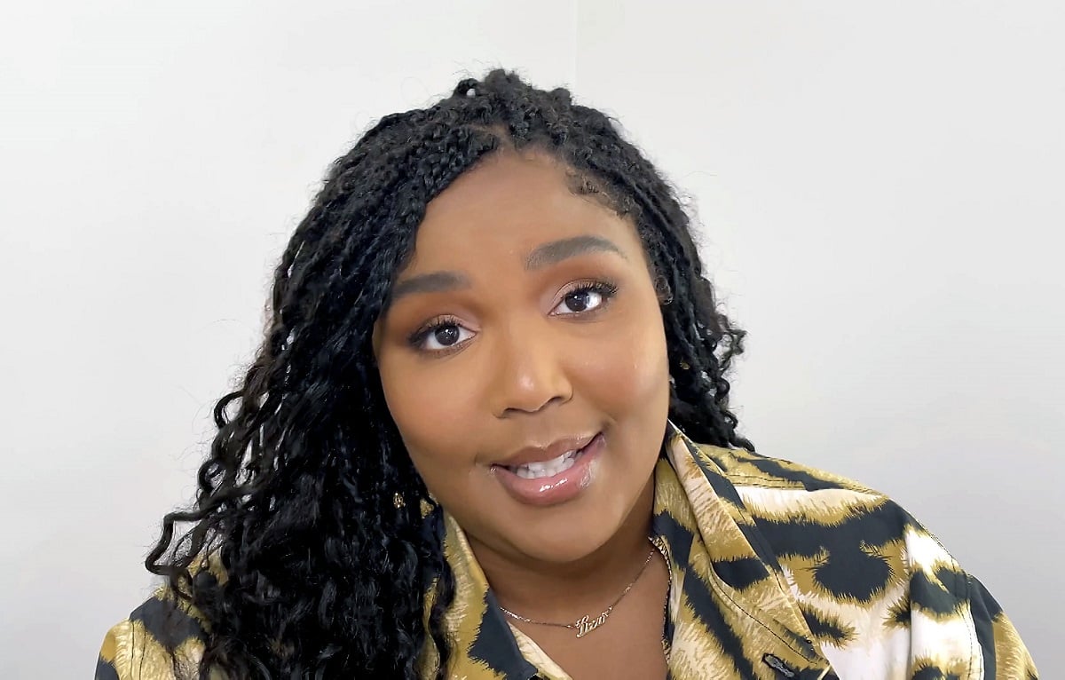 Lizzo, singer and creator of a viral chicken sandwich recipe, looks into the camera