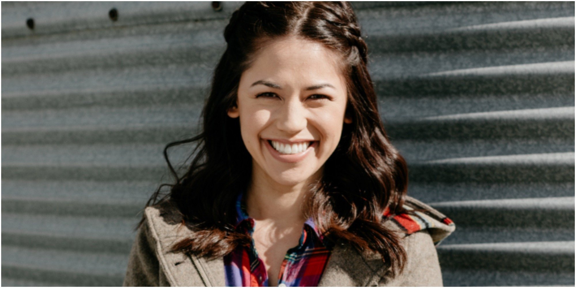 Molly Yeh smiles for the camera in a tan jacket.