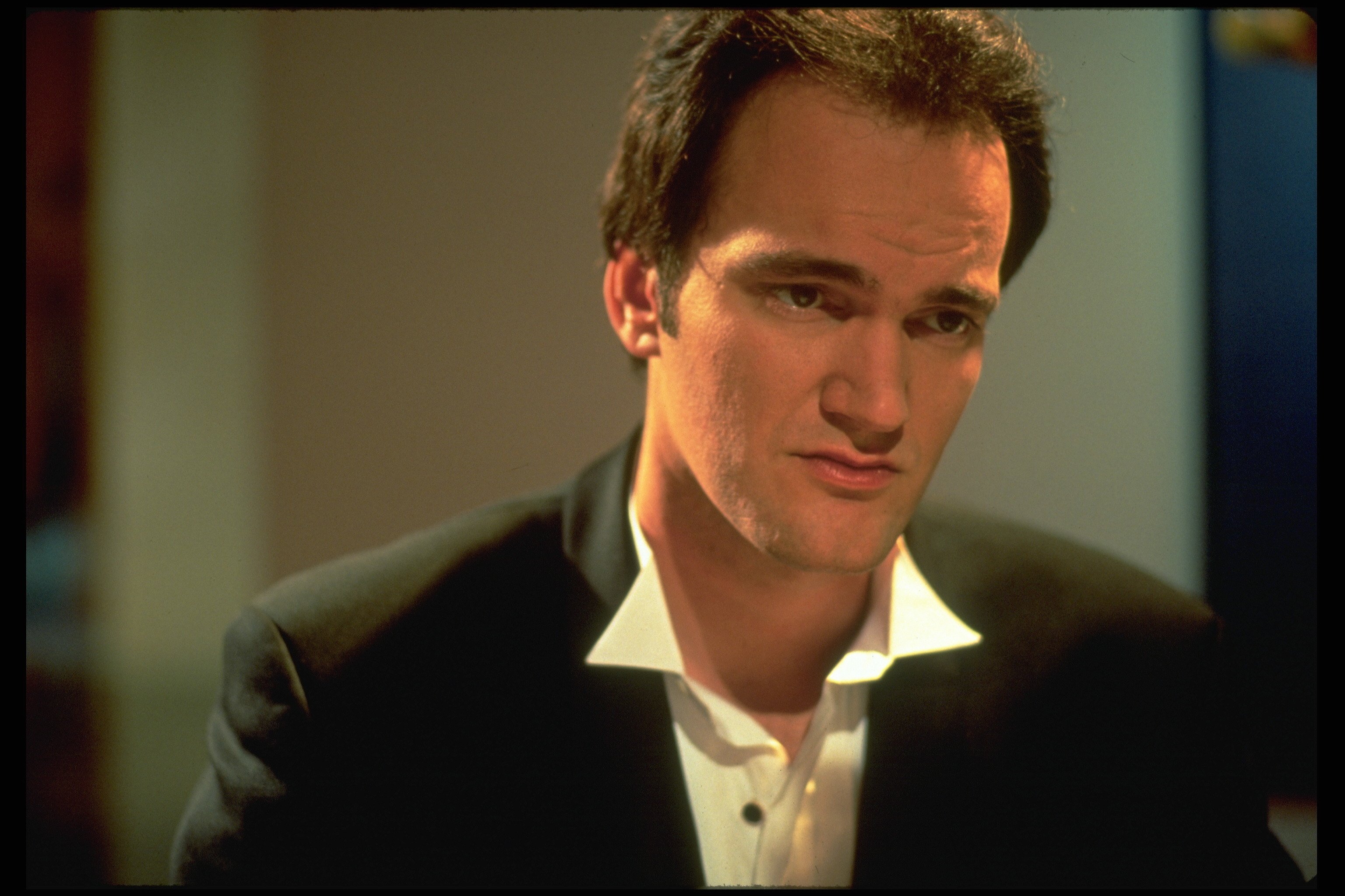 Quentin Tarantino wearing a suit around the time he made 'Pulp Fiction'
