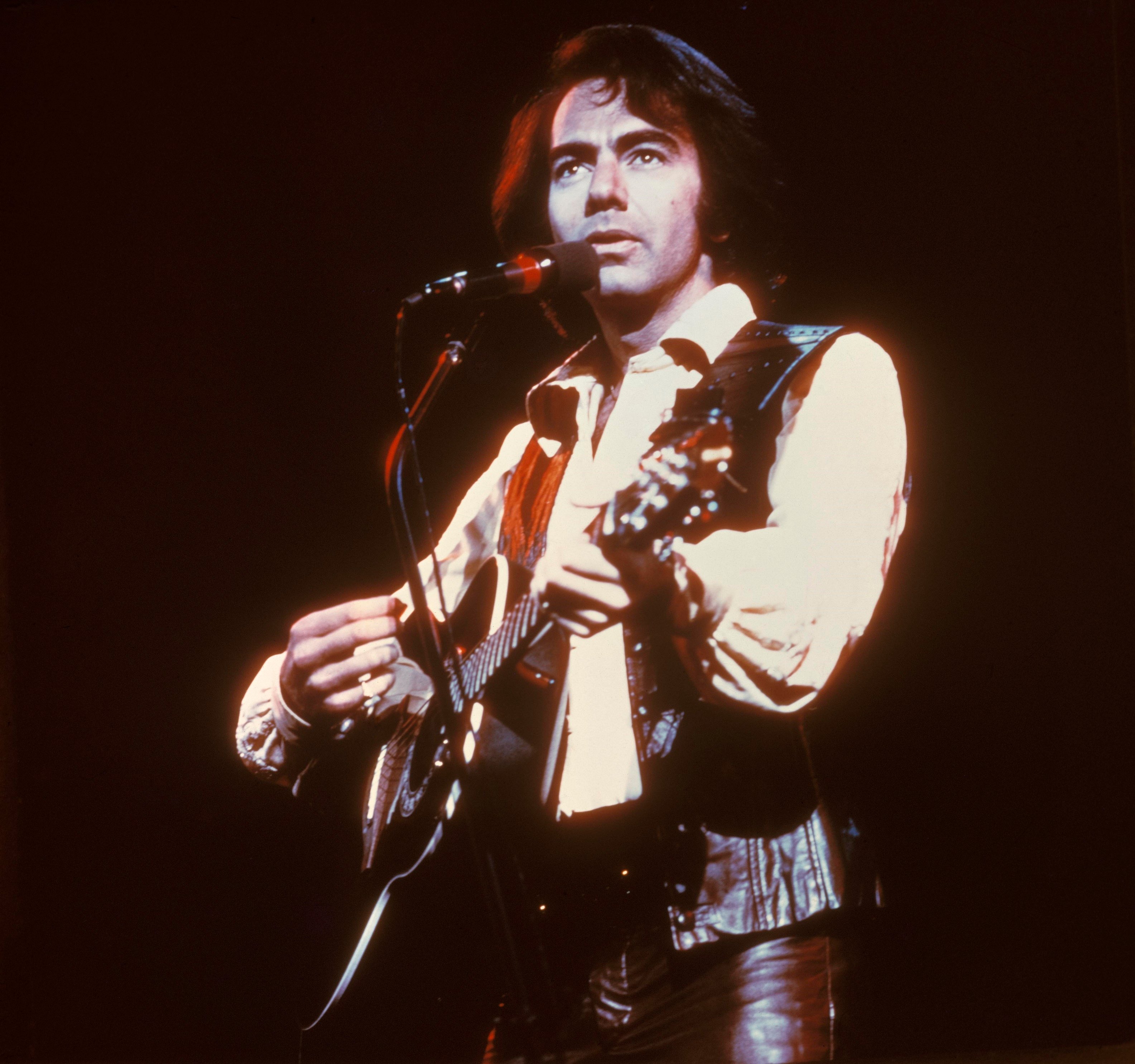 Neil Diamond with a guitar