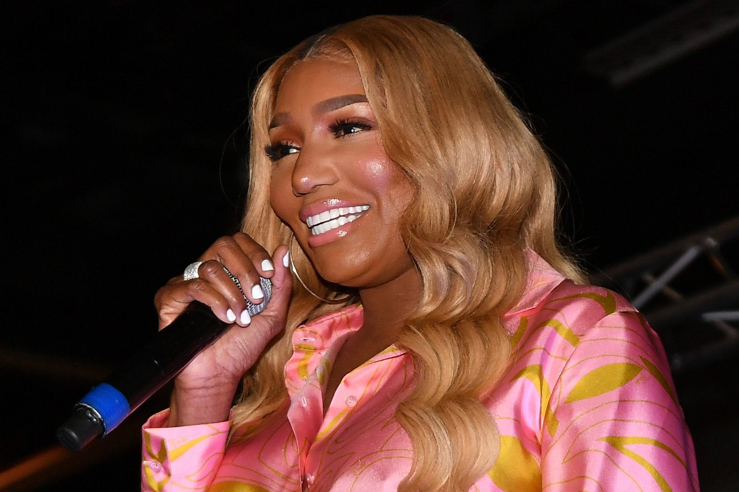 Nene Leakes holding a microphone and smiling