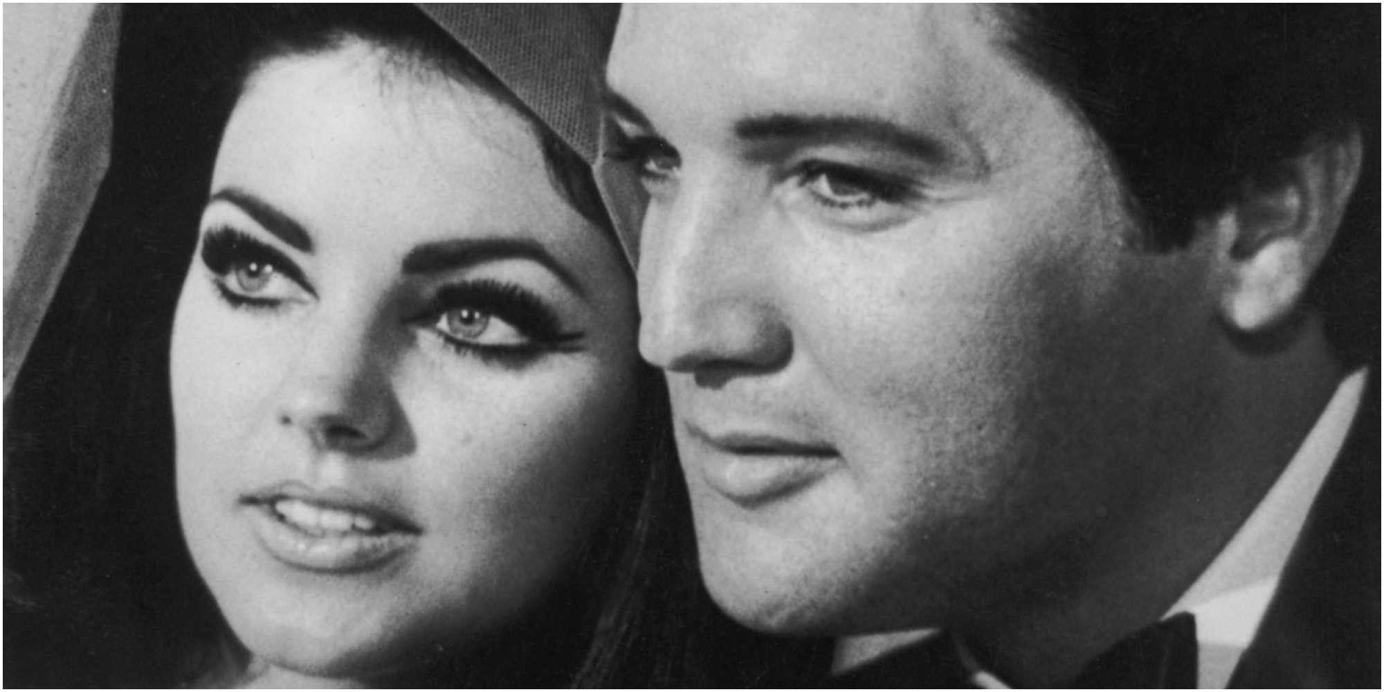 Priscilla and Elvis Presley pose cheek to cheek on their wedding day.
