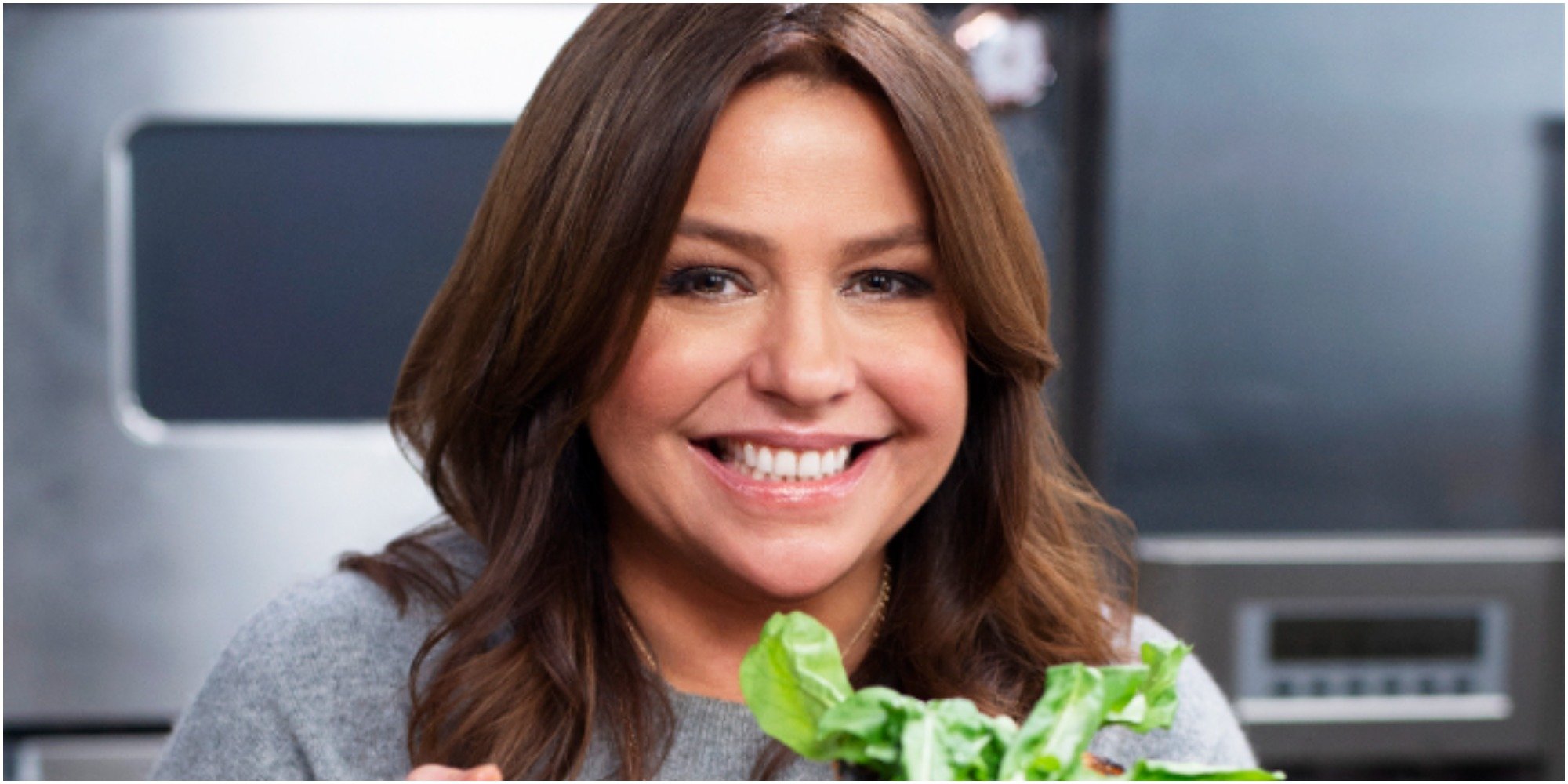 Rachael Ray poses for a photograph in a kitchen.