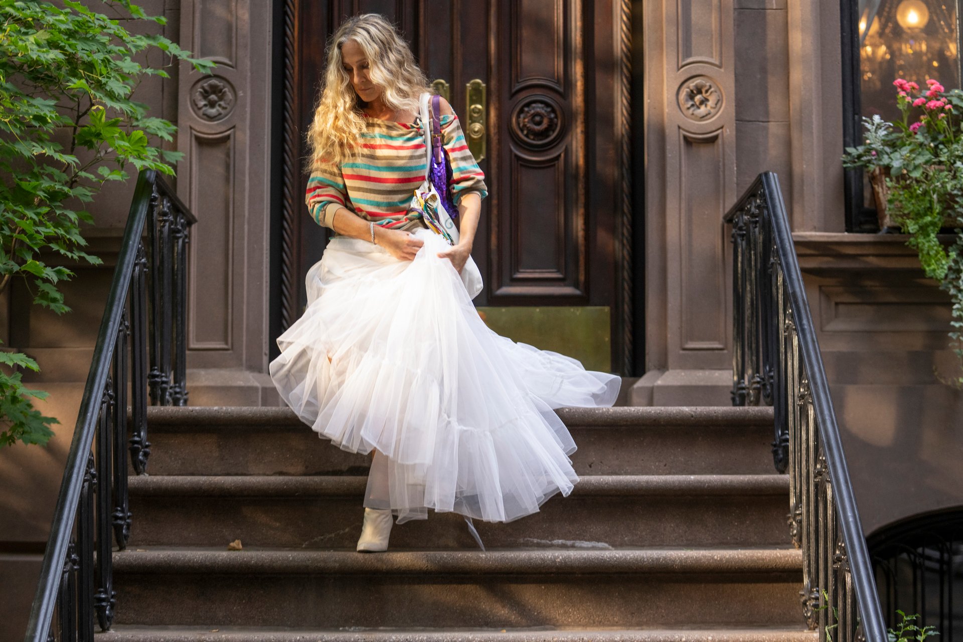 Sarah Jessica Parker in front of Carrie Bradshaw's apartment in 'And Just Like That...'