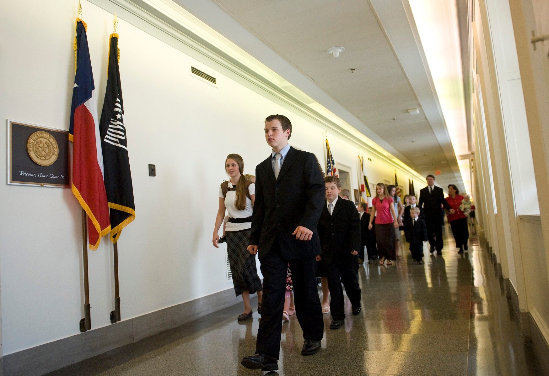 The Duggar family walks down the hall of the Longworth House Office Building in 2009