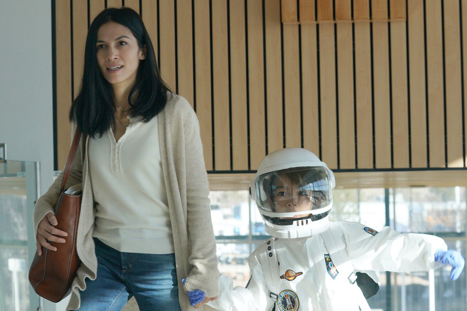 Elodie Yung as Thony De La Rosa, alentino and Sebastien LaSalle as her son in The Cleaning Lady