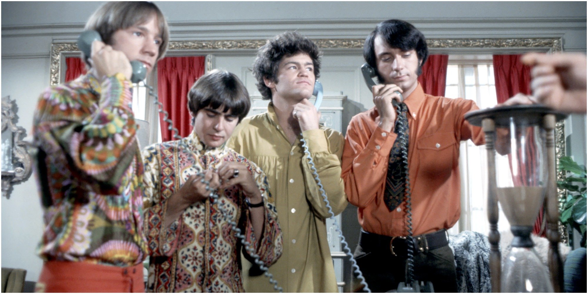 The cast of The Monkees each holds a telephone to their ears.
