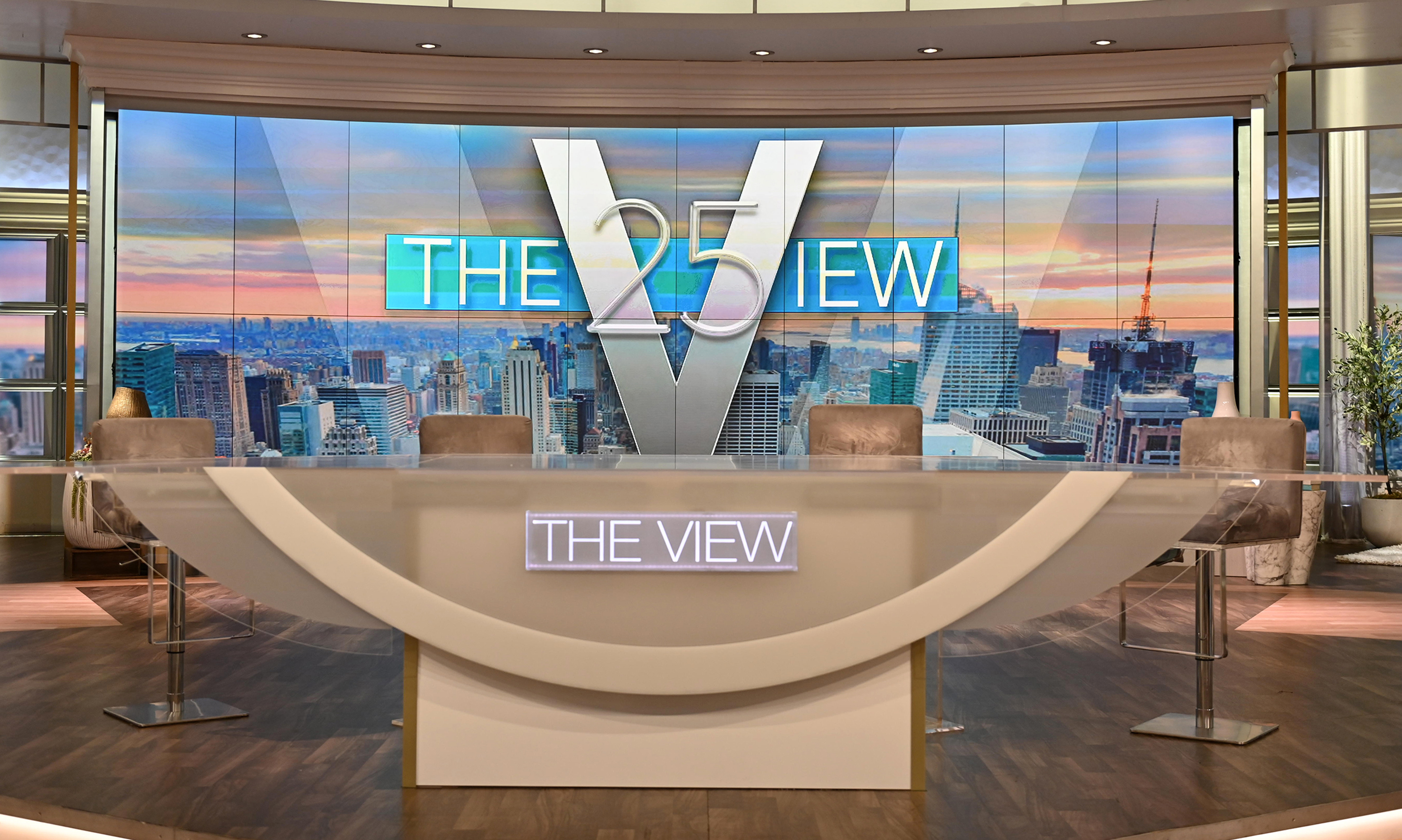 'The View' set with empty chairs and the show's logo in the big screen in the back