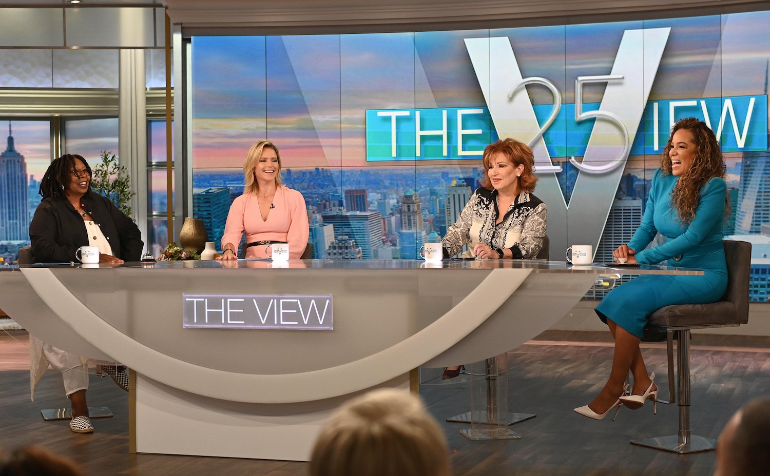 Whoopi Goldberg, Sara Haines, Joy Behar, and Sunny Hostin sitting around 'The View' table