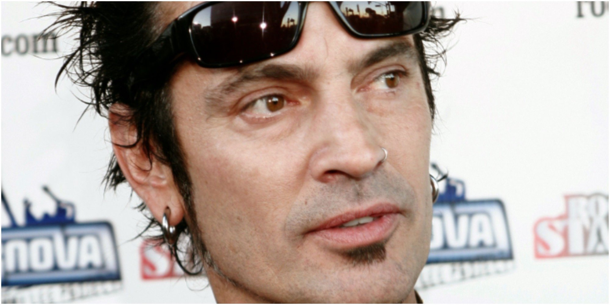 Tommy Lee wears sunglasses on his forehead.