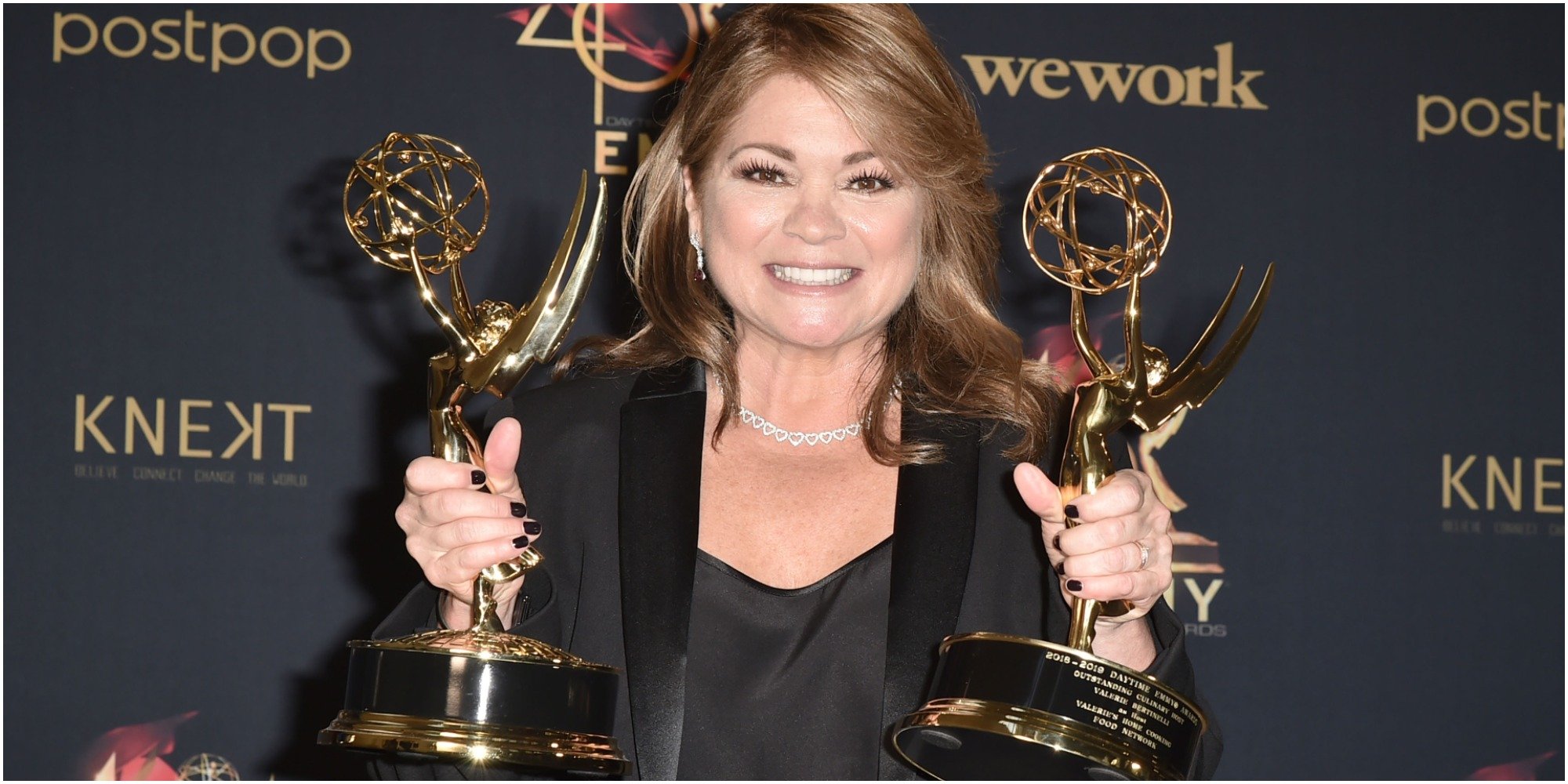 Valerie Bertinelli poses with two emmy awards in 2019.