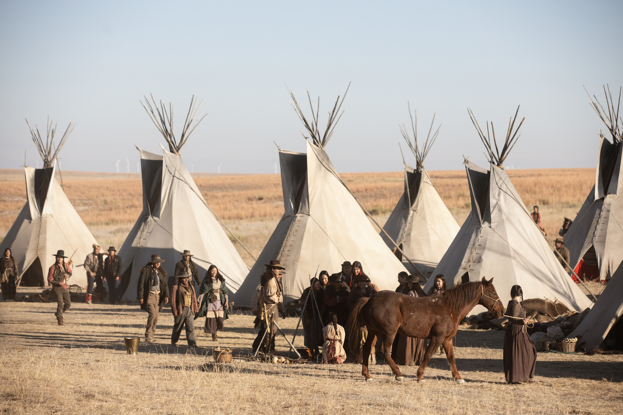 An image of teepee tents with horses outside of them in the 'Yellowstone' spinoff 1883