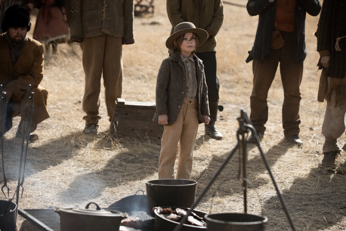 Audie Rick as John of the Paramount+ original series 1883. John stands near the cook's pots and pans. 