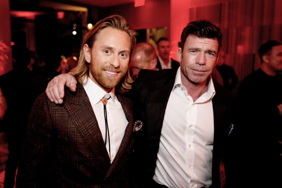 1883 star Eric Nelsen wearing a bolo and a suit and creator Taylor Sheridan in a dress shirt and black jacket at the shows premiere