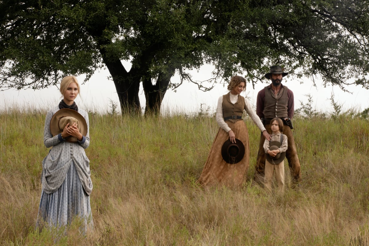 Isabel May, Faith Hill, Tim McGraw, and Audie Rick standing together in a field in '1883'