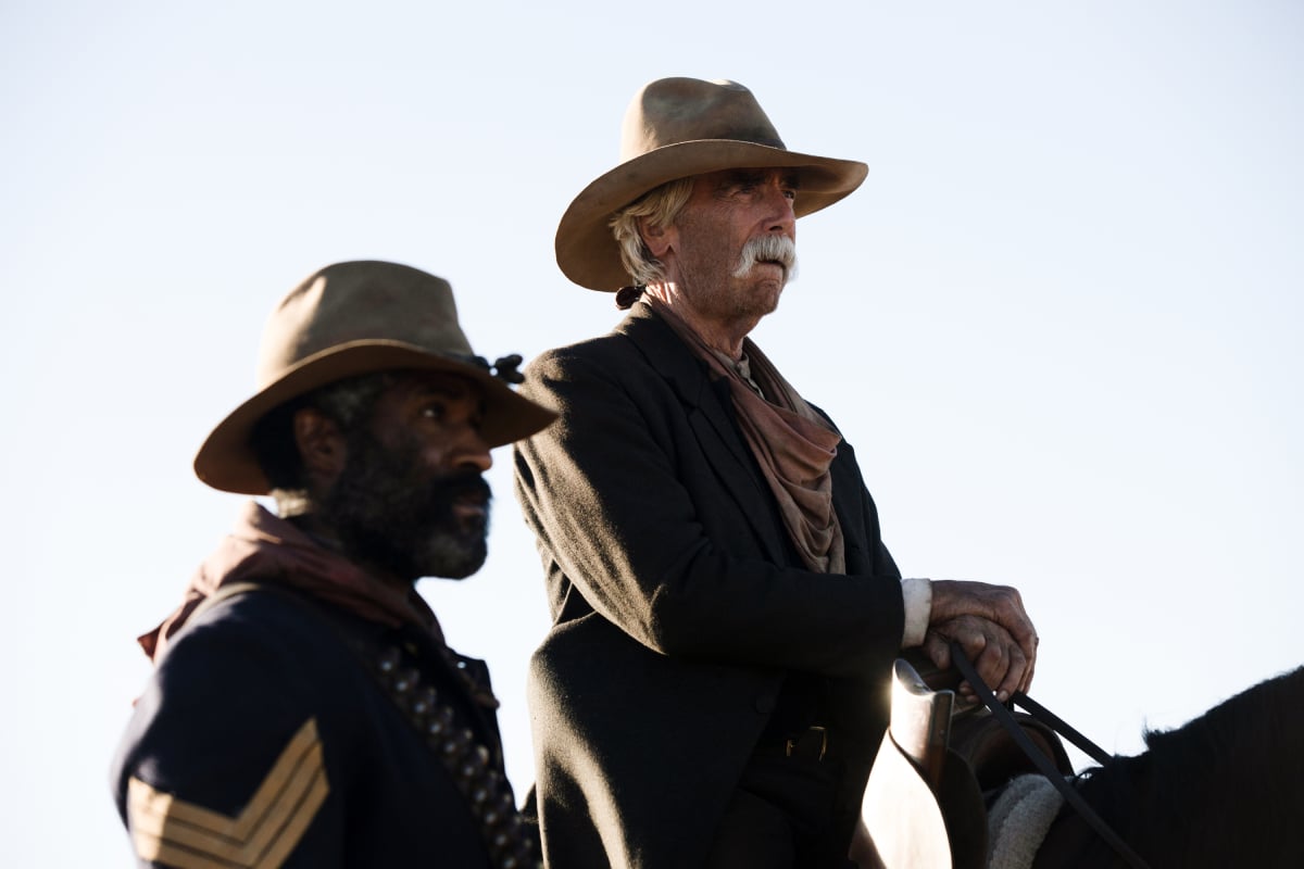 LaMonica Garrett as Thomas and Sam Elliott as Shea of the Paramount+ original series 1883. Shea sits on his horse and Thomas stands next to him.