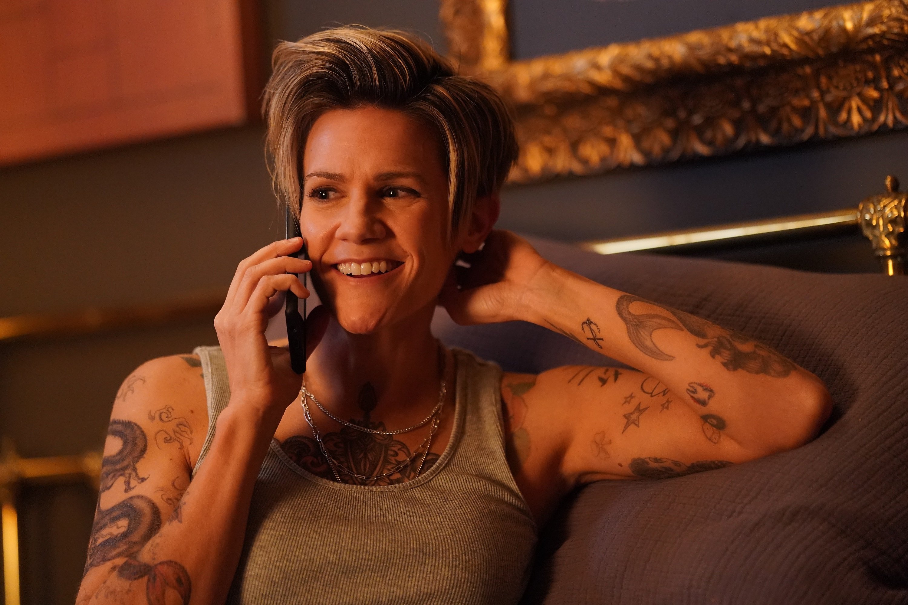 'A Million Little Things' Season 4 guest cast member Cameron Esposito talking on the phone as Greta Strobe