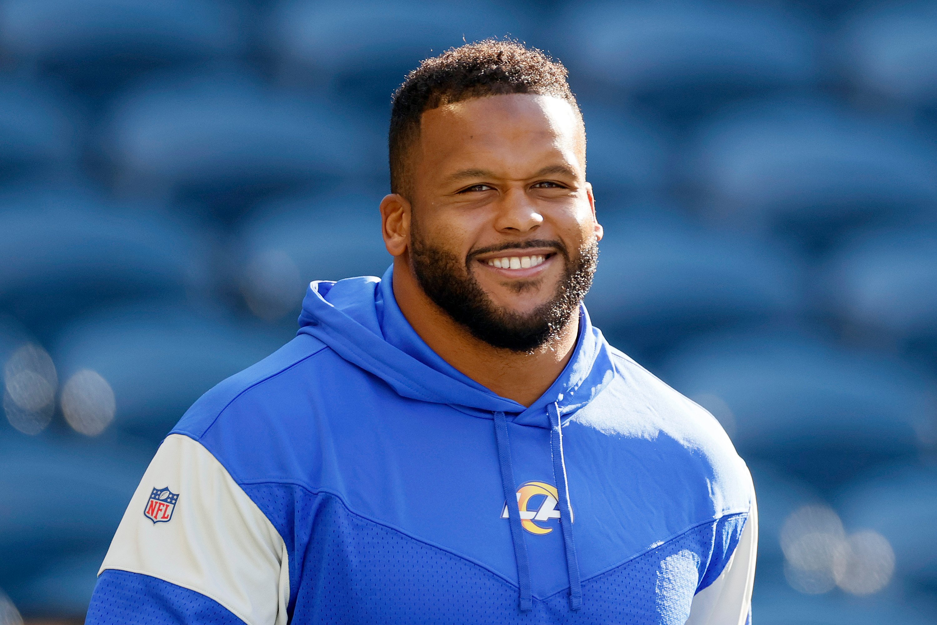 Aaron Donald of the Los Angeles Rams smiling on the field before a game against the Seattle Seahawks