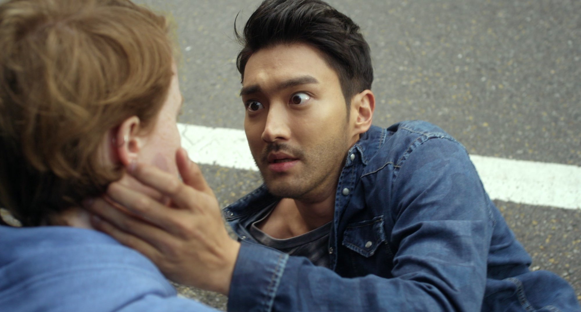 Actor Choi Siwon in 'Dramaland' cameo touching face of female lead.