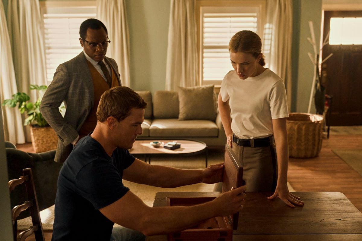 Seen standing and sitting around a table, Alan Ritchson, Malcolm Goodwin, and Willa Fitzgerald in 'Reacher' Season 1